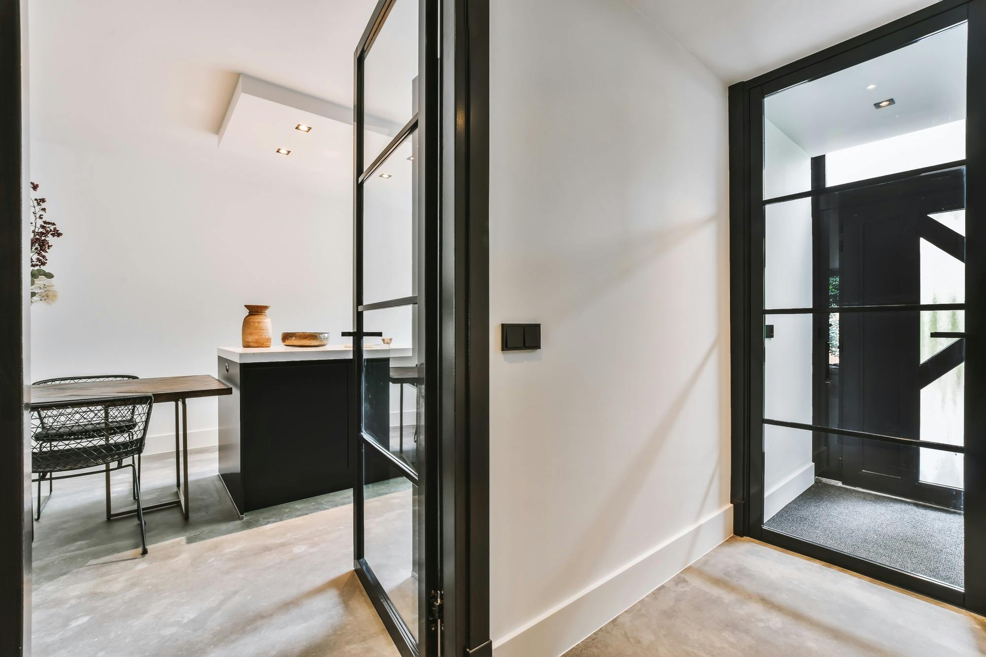 Stylish corridor with glass doors in black frames