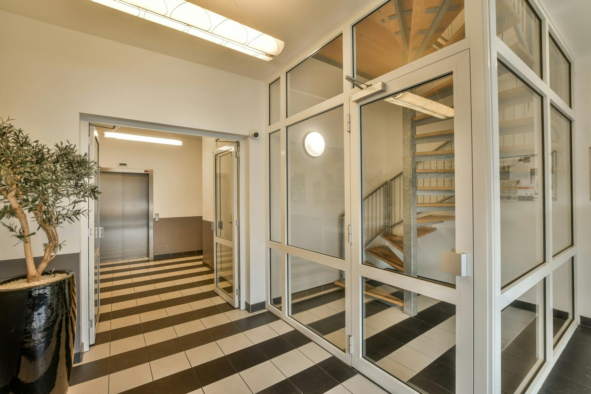 a lobby with a checkered floor and glass
