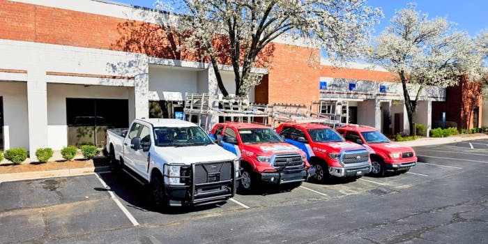 glass governor of atlanta | glass and mirror shop with trucks in the front lot